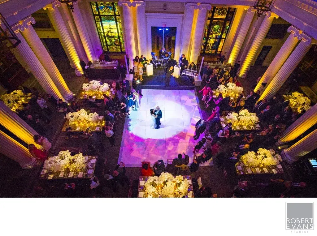 A first dance surrounded by dramatic purple and gold reception lighting A first dance surrounded by dramatic purple and gold reception lighting