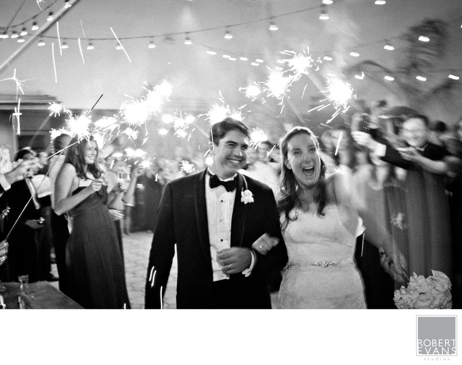 Newlyweds leaving their reception through a line of sparklers Newlyweds leaving their reception through a line of sparklers